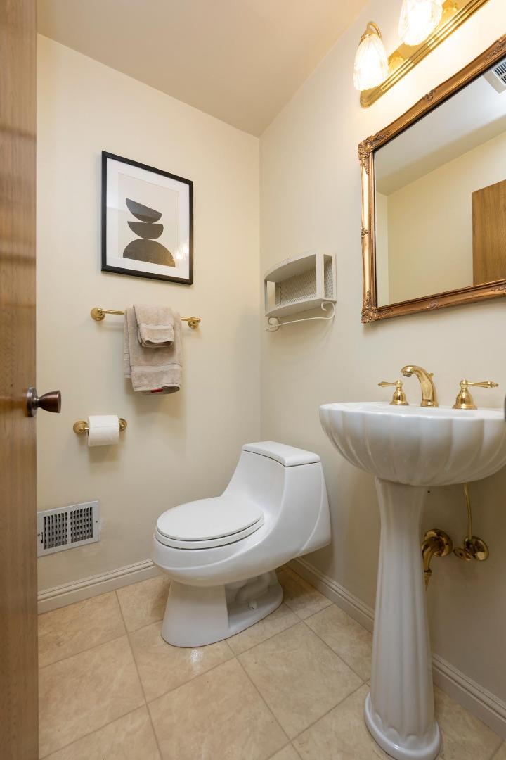 1255 Tuolumne Road Millbrae, CA 94030 - Photo 29 of 42 a bathroom with a toilet sink and mirror
