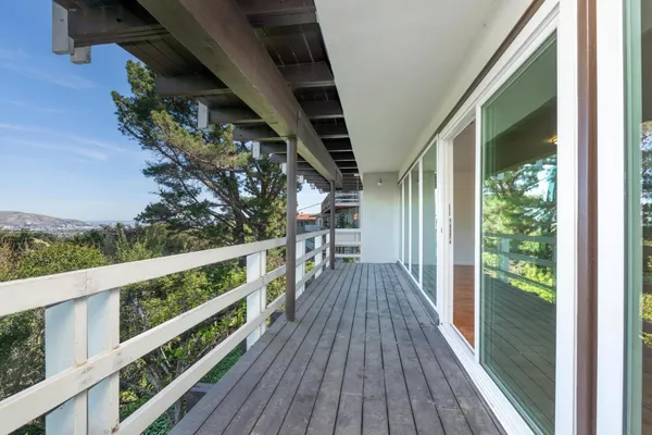 a view of balcony with wooden floor