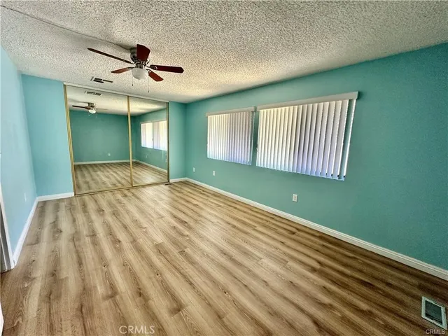 a bedroom with a bed and a ceiling fan