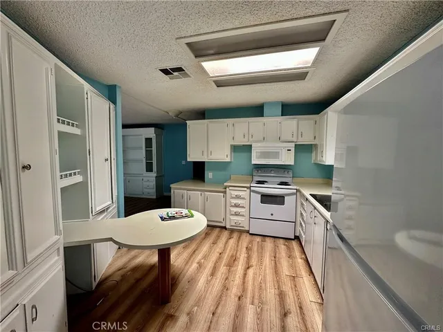 a kitchen with a sink stainless steel appliances and cabinets