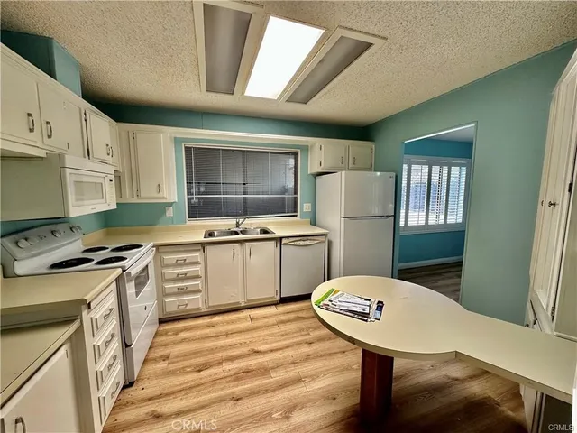 a kitchen with a stove a refrigerator and a sink