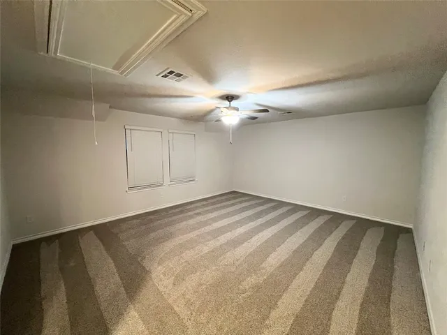 a view of a room with a ceiling fan