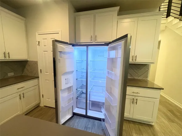 a kitchen with stainless steel appliances a refrigerator and cabinets