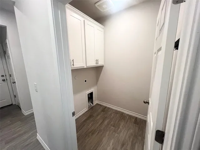 a view of storage and utility room with wooden floor