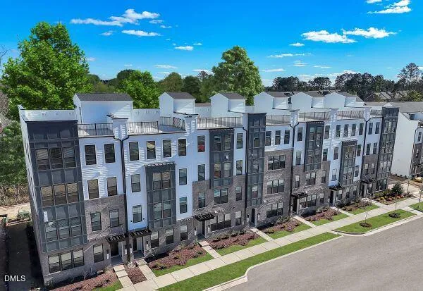 a kitchen with stainless steel appliances kitchen island granite countertop a refrigerator stove and sink
