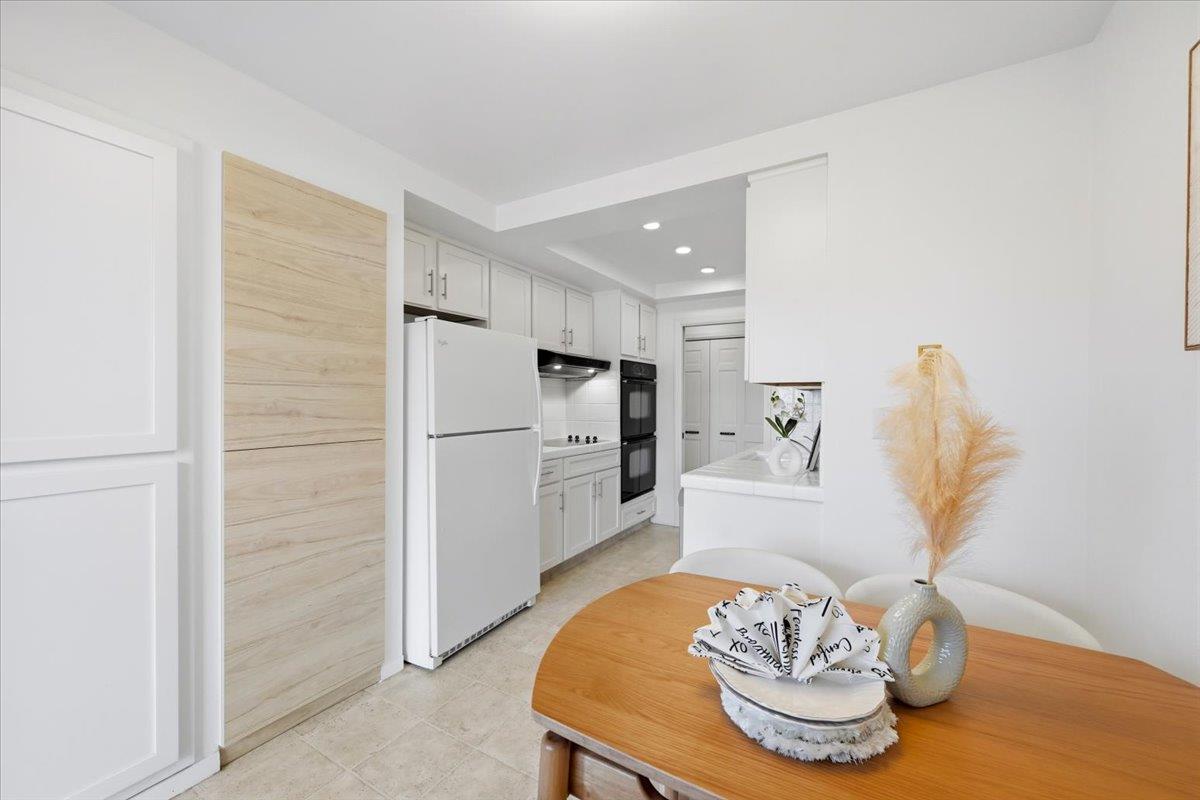 555 Palm Avenue, Unit 202 Millbrae, CA 94030 - Photo 18 of 40 a kitchen with a table and a refrigerator