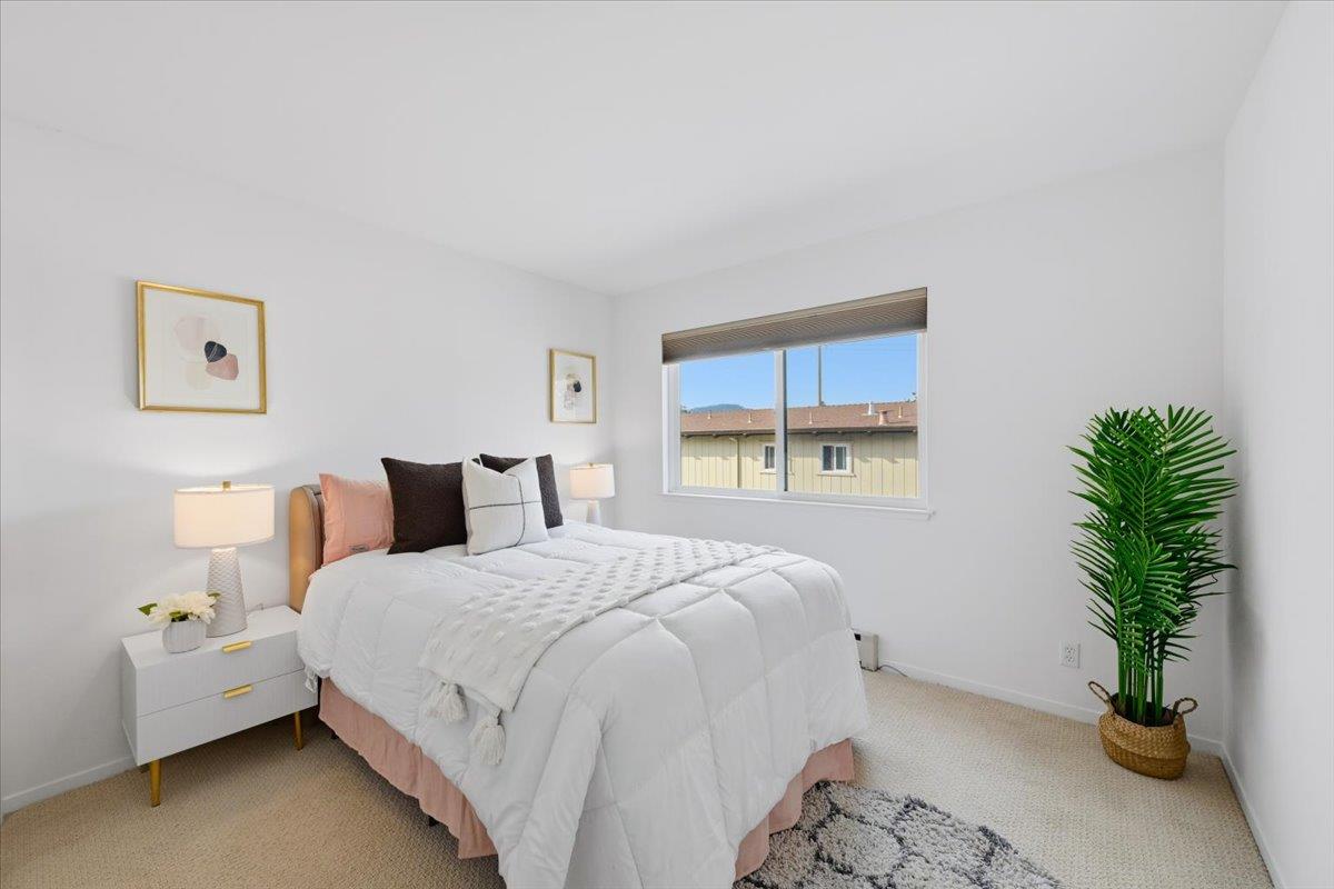 555 Palm Avenue, Unit 202 Millbrae, CA 94030 - Photo 19 of 40 a bedroom with a bed and a potted plant