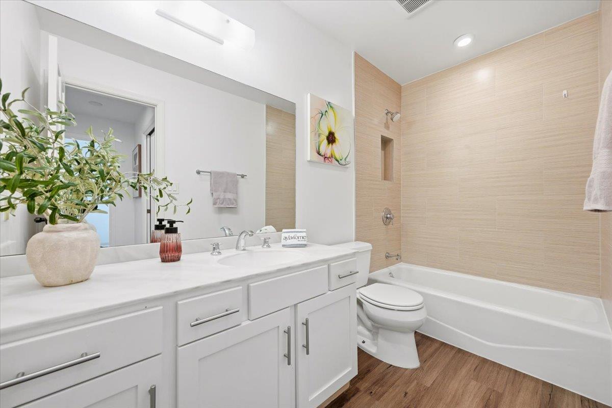 555 Palm Avenue, Unit 202 Millbrae, CA 94030 - Photo 21 of 40 a bathroom with a sink a toilet and a large mirror