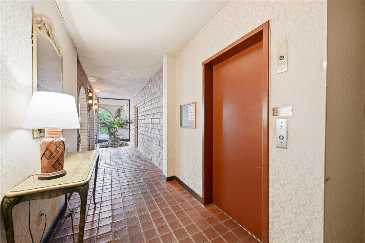 555 Palm Avenue, Unit 202 Millbrae, CA 94030 - Photo 6 of 40 a view of a hallway to a livingroom with furniture and a window