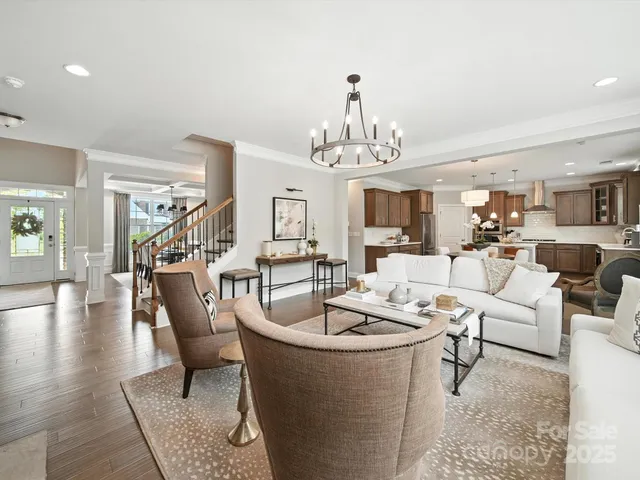 a living room with furniture and a chandelier