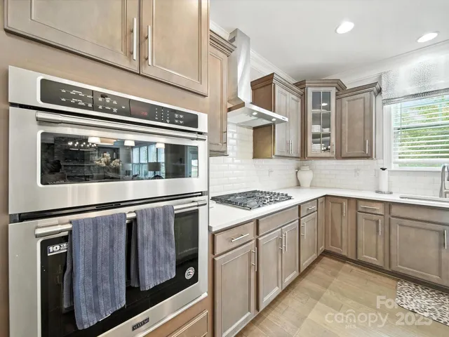 a kitchen with stainless steel appliances granite countertop a stove and a microwave