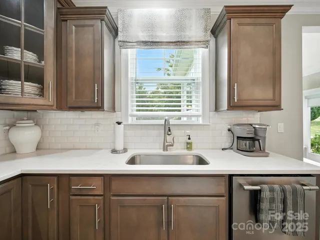 a kitchen with a sink cabinets and window