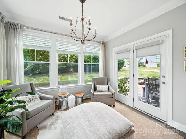 a living room with furniture and a chandelier