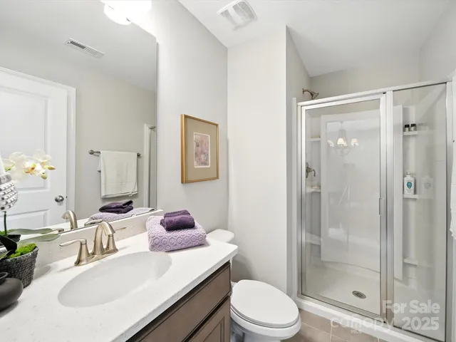 a living room with furniture a potted plant and a large window