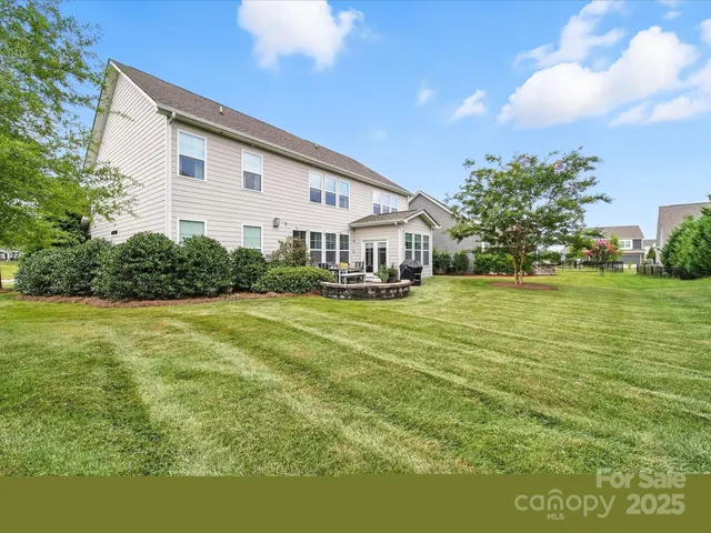 a front view of a house with yard and green space