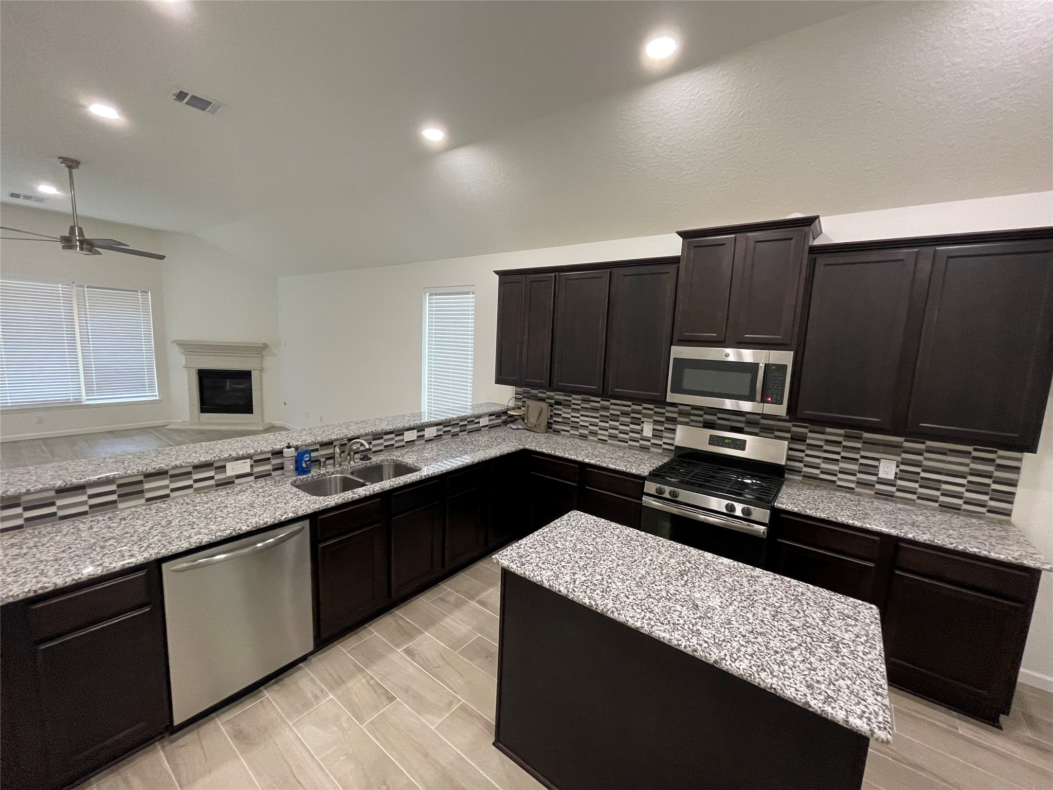 4118 Guild Meadows Drive Houston, TX 77084 - Photo 20 of 35 a kitchen with a sink stove and refrigerator