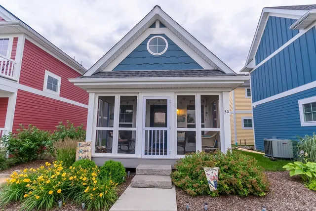 a front view of a house with a garden