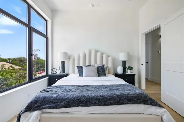 a bedroom with a large bed and a large window