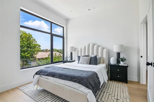 a bedroom with a large bed and a large window
