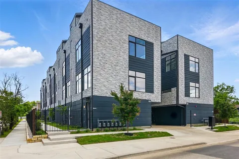 a view of a brick building next to a road