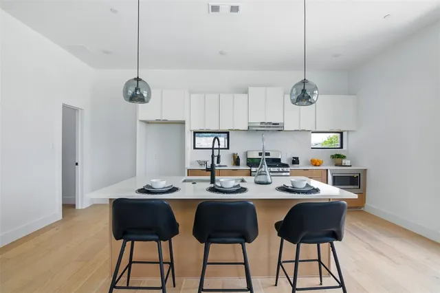 a kitchen with a dining table and chairs