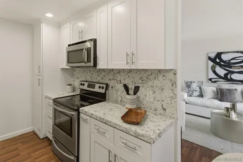 a kitchen with stainless steel appliances granite countertop a sink stove and cabinets