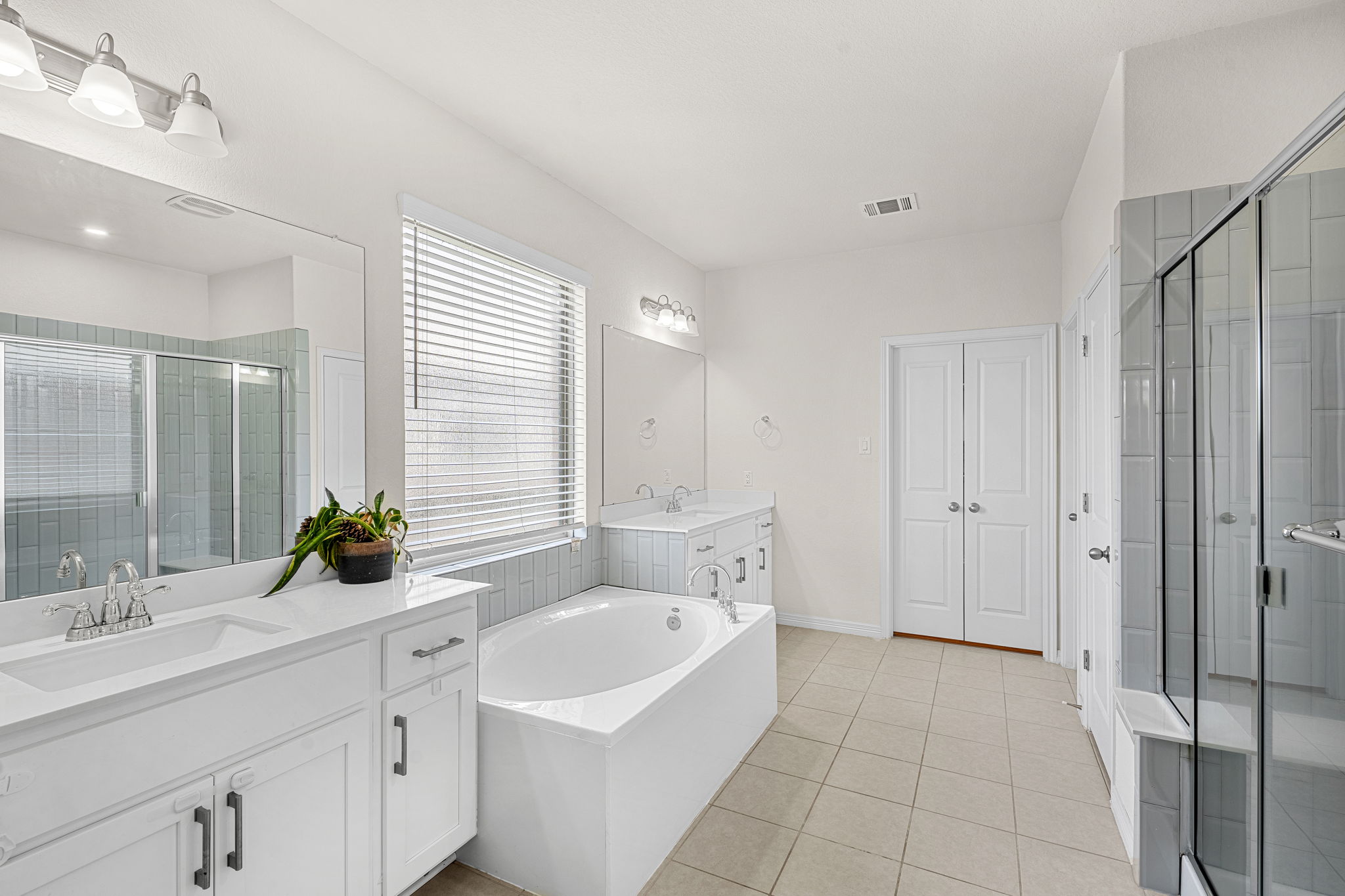 20813 Carries Ranch Road Pflugerville, TX 78660 - Photo 19 of 40 Clean lines and a spacious layout define this modern bathroom with a soaking tub.