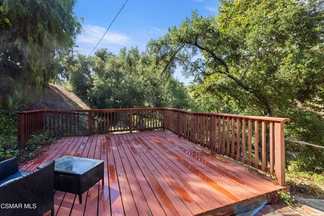 a view of a wooden deck and a yard
