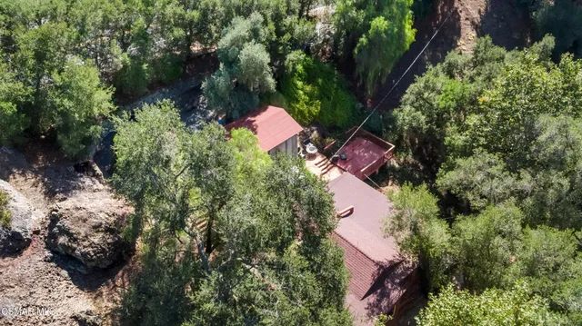 an aerial view of a house with a yard and lake view