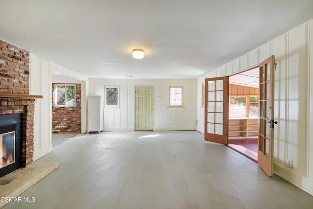 a spacious bedroom with a bed and a window