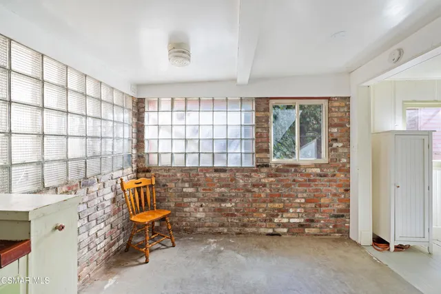 a kitchen with a refrigerator a sink and wooden cabinets