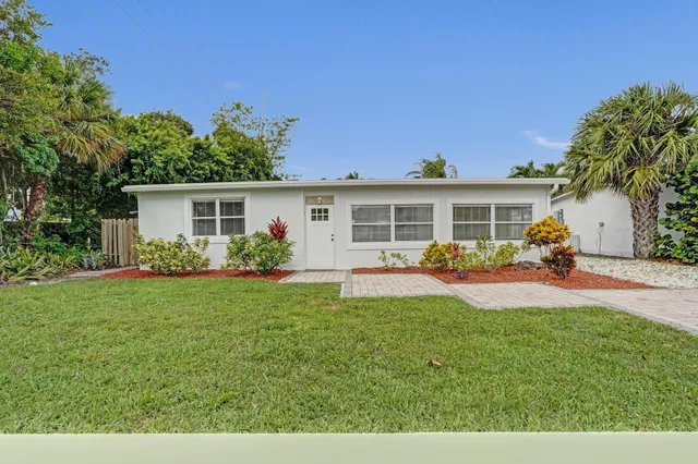 a view of a house with a backyard and a patio
