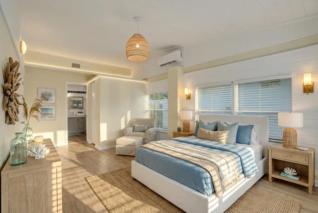 a bedroom with bed and a chandelier