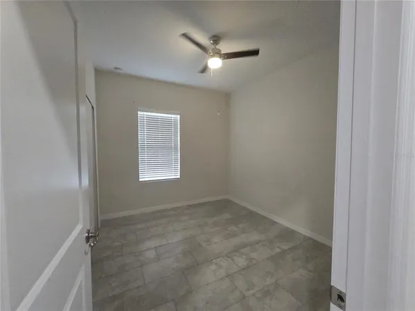 a view of a livingroom with a ceiling fan and window