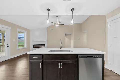 a view of a kitchen with a sink a refrigerator and window