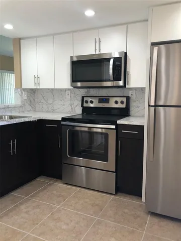 a kitchen with stainless steel appliances and view of microwave