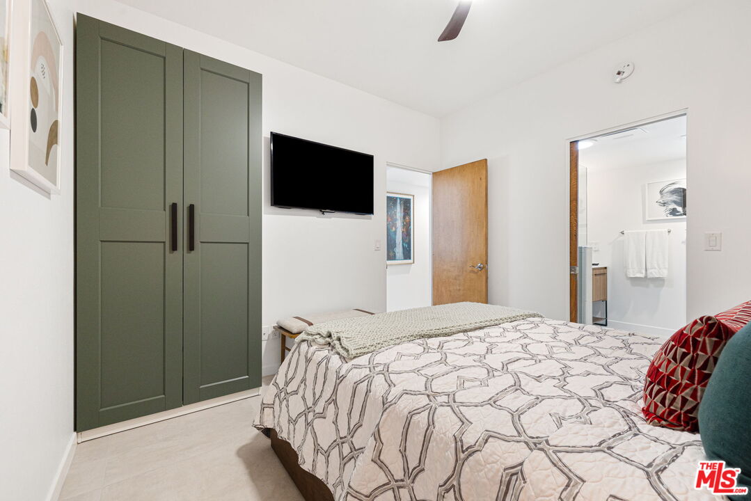 1414 Sagebrush Road Palm Springs, CA 92264 - Photo 31 of 48 a bedroom with a bed and a flat screen tv