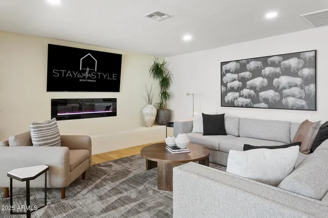 a bathroom with a double vanity sink a mirror and next to a window