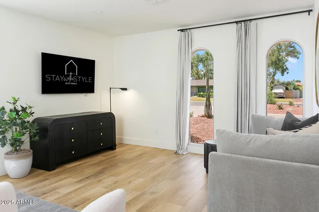 a bedroom with a bed and a large window