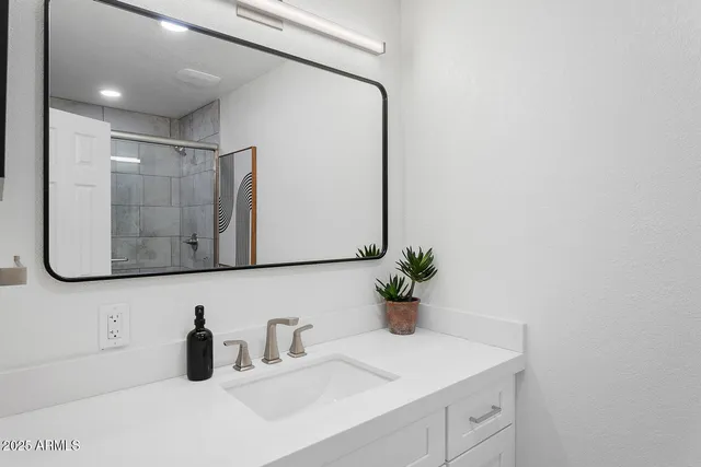 a spacious bathroom with a bathtub sink and mirror