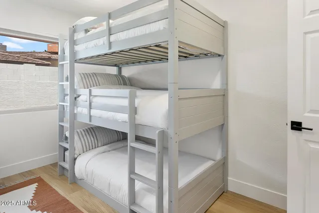 a bedroom with a bed and with the view of cabinet