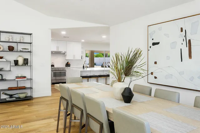 a kitchen with stainless steel appliances a sink a stove a refrigerator and cabinets