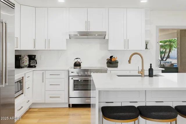 a living room with furniture a rug and white walls