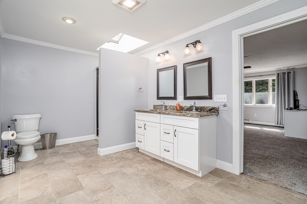 34 Hermit Road Alton, NH 03810 - Photo 17 of 37 a spacious bathroom with a granite countertop sink mirror and toilet
