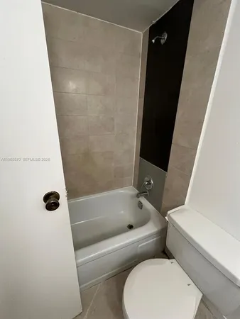 a bathroom with a toilet and a tub