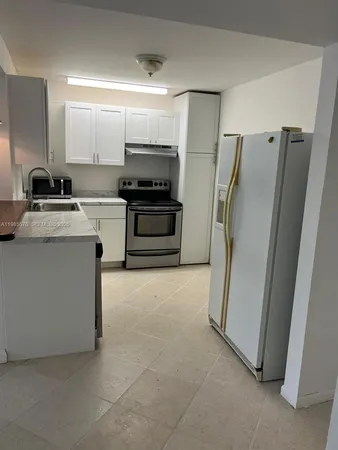 a kitchen with stainless steel appliances a refrigerator sink and microwave