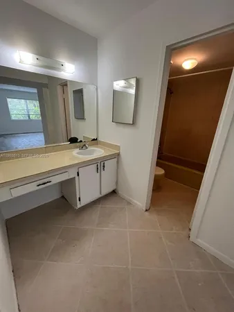 a bathroom with a sink a mirror and a bathtub