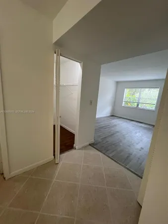 an empty room with windows and entrance