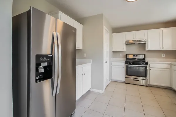 a kitchen with stainless steel appliances a refrigerator sink and cabinets