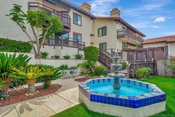 a view of a house with a swimming pool and sitting area